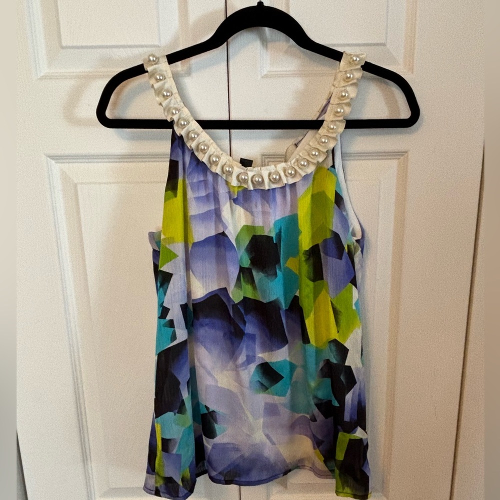 Woman’s size large sleeveless Elegant blouse with pearl accents, and ribbon.